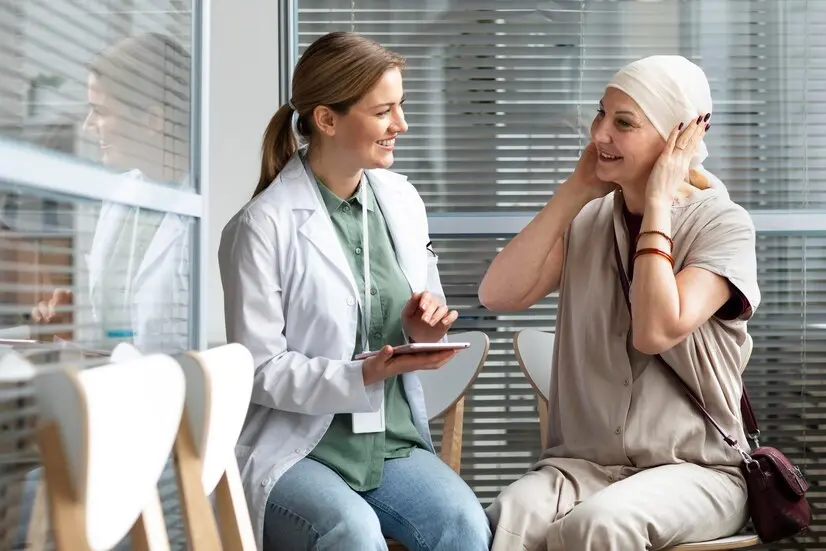 Doctor conversing with a patient wearing a headscarf in a clinic